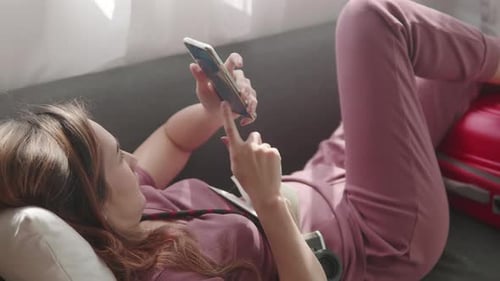 Woman booking flight online with her passport and credit card before travel trip