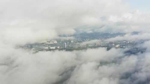 An Epic Drone View of Vladivostok in Cloudy Weather with Low Cinematic Fog