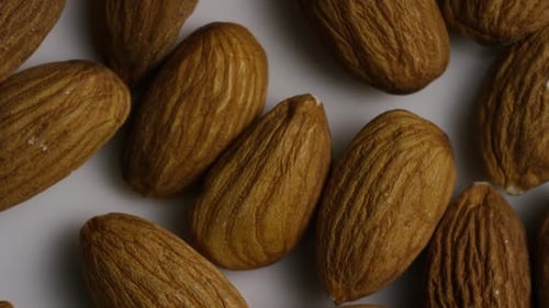 Cinematic, rotating shot of almonds on a white surface - ALMONDS 004