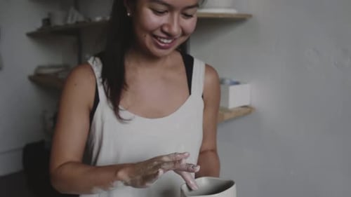 Potier asiatique souriant avec pot en argile