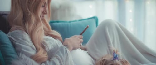 Woman Relaxes with Dog and Cellphone