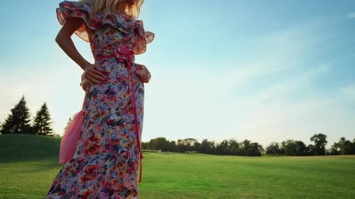 Cheerful Mother with Daughter Dancing on Green Grass