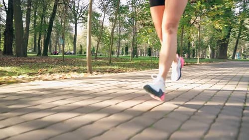 Close Up of Woman in Sport Sneakers Running Outdoors