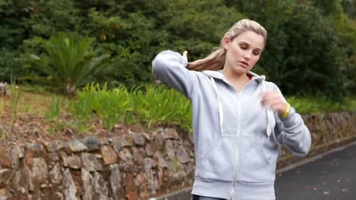Woman Adjusts Hoodie Before Starting Workout