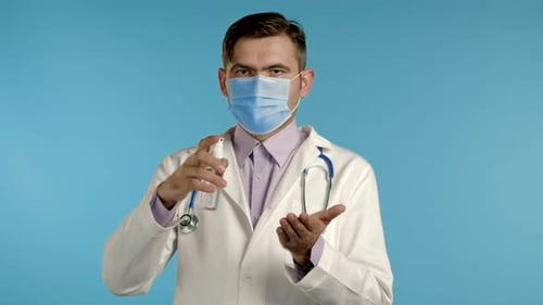 Doctor Demonstrates Hand Sanitizing Technique with Face Mask