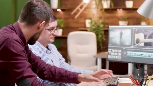 Bearded Young Videographer in the Office Talking with His Manager