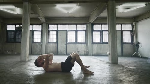 Man Doing Crunches in an Urban Setting