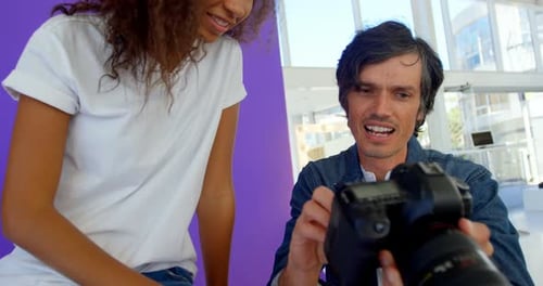 Photographer and Model Reviewing Images on Camera
