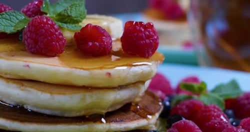 Honey Drizzled Over Stack of Pancakes with Berries
