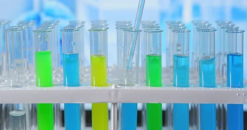 Lab Assistant Adding Green Liquid in Test Tube, Monitoring Chemical Reaction. Technician Carefully