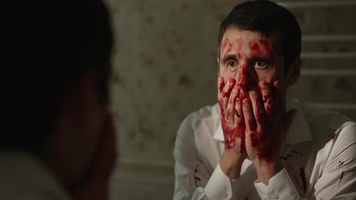 Man with Blood on His Face Looks in Mirror
