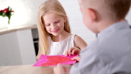 Child Giving Handmade Card to Friend
