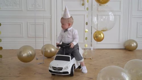Adorable Infant on Toy Car Surrounded by Balloons