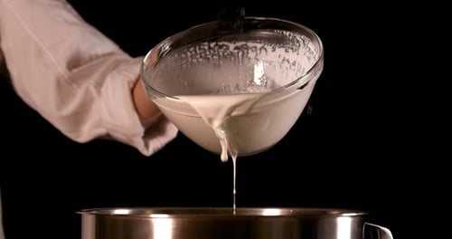 Frothy Liquid Being Poured Into Bowl