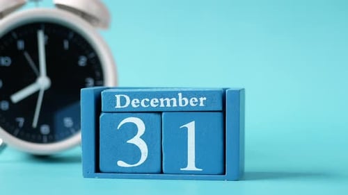 December 31st Calendar Beside Clock Ticking