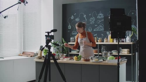 Young Woman Recording Culinary Vlog in Kitchen