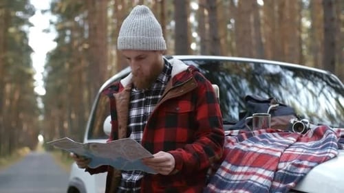 Bearded Man in Beanie Studying Map