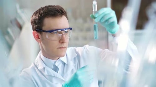 Scientist Examining Liquid in Test Tube in Lab