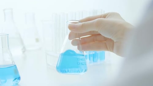 Close up of Hand Holding Science Flask