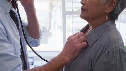 Medical Check-up: Doctor Examines Patient with Stethoscope