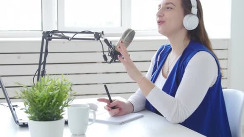 Woman Recording a Podcast at Home Studio