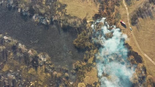 Aerial View. Spring Dry Grass Burns During Drought Hot Weather. Bush Fire And Smoke. Fire Engine