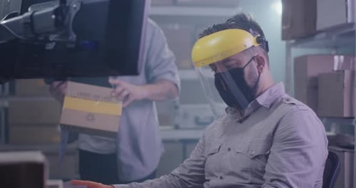 Men Checking Information About Package on Computer