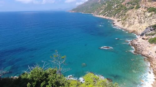 Aerial Clear Reef and Rocky Untouched Coastline of Bright Turquoise Sea