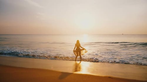 Epic Silhouette Shot of Young Happy Woman Watching Amazing Sunset on Idyllic Golden Ocean Beach