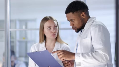 Healthcare Workers Collaborating on Research in Modern Lab