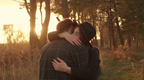 Romantic Couple Embracing in Golden Field at Sunset