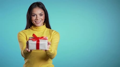 Woman Smiling Holding Out Birthday Gift