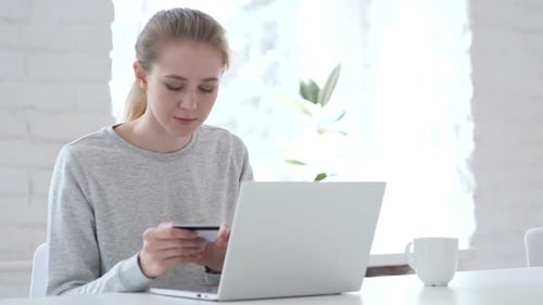 Young Woman Shopping Online With Laptop and Card