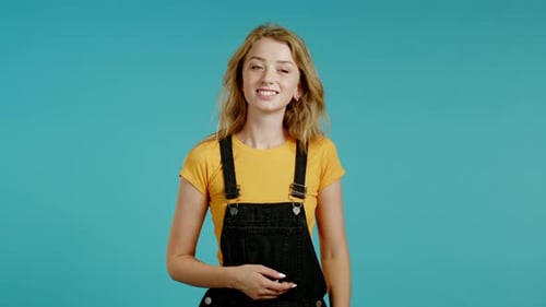 Young Woman Poses on Blue Background