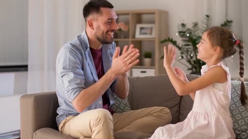 Playful Father and Daughter Game at Home