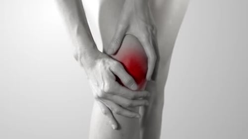 Hands Hold Knee with Pain