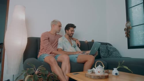 Couple Relaxing on Couch with Laptop