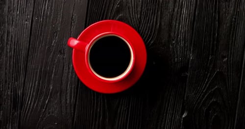 Red Coffee Cup on Dark Wooden Table