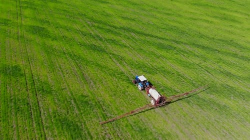 Tractor Sprayer Works in the Field.