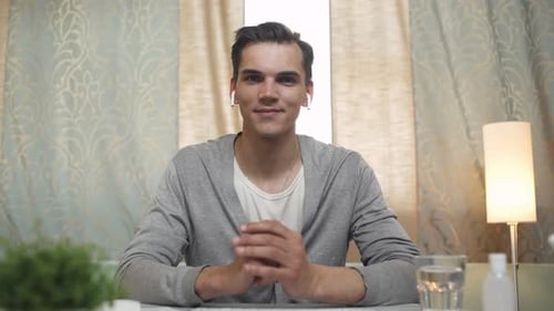 Young Adult Recording a Video at his Desk