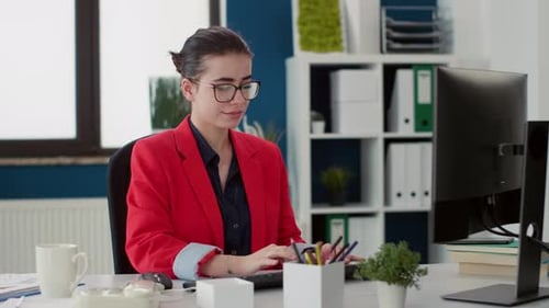 Office Employee Analyzing Research Project on Computer
