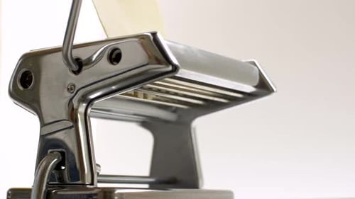 Fresh Pasta Dough Being Fed Into Pasta Machine