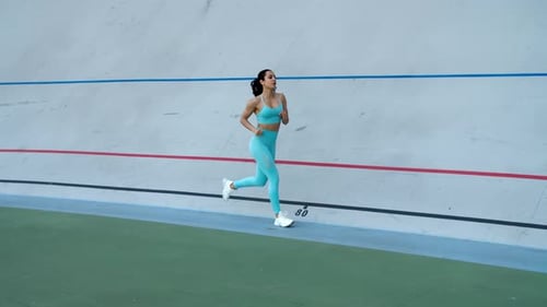 Sport Woman Running at Sport Stadium. Female Runner Running in Sportswear