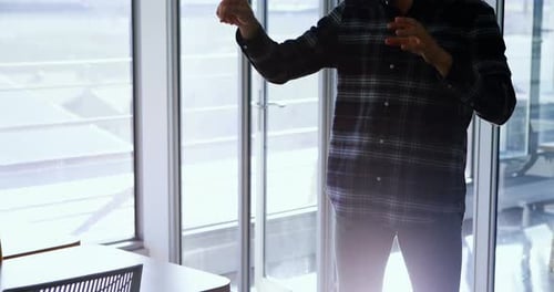 Man Using Virtual Reality Headset Indoors at Workplace