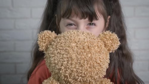 Enjoying time with teddy bear.