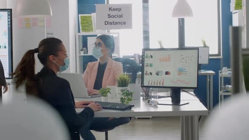Women Wearing Face Masks Working in Office