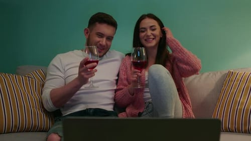 Smiling Couple Relaxing at Home with Wine