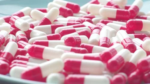 Red and White Capsules on a Plate