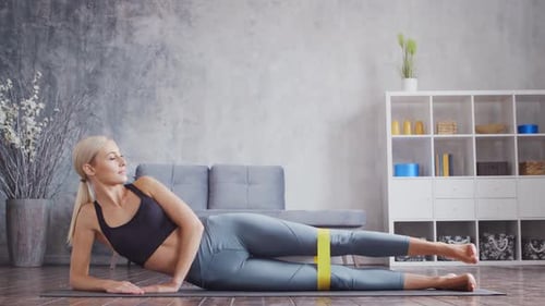 Woman Exercising with Resistance Band at Home