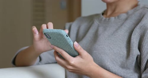 Person Using Smartphone Indoors Close Up